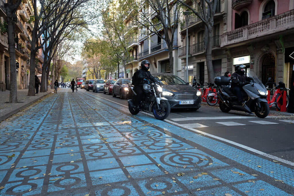Motorized traffic beside a new pedestrian zone on Barcelona's Rocafort Street