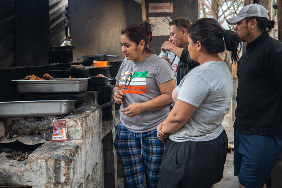 Outside kitchen Women cook in the outdoor kitchen at the Agape shelter in Tijuana